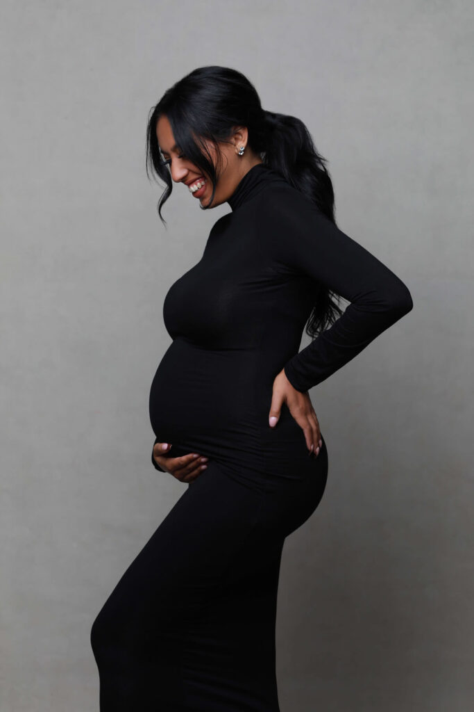 maternity photo with black dress and happy mama to be